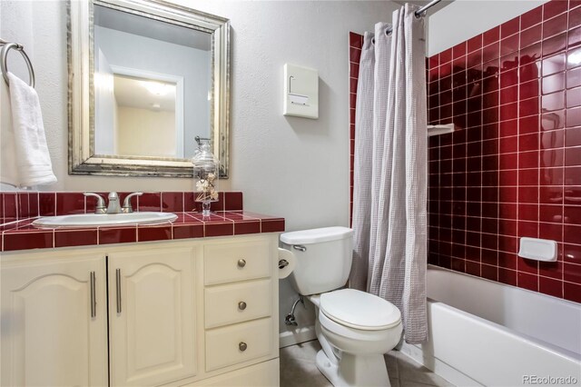 bathroom with shower / bath combination with curtain, vanity, and toilet