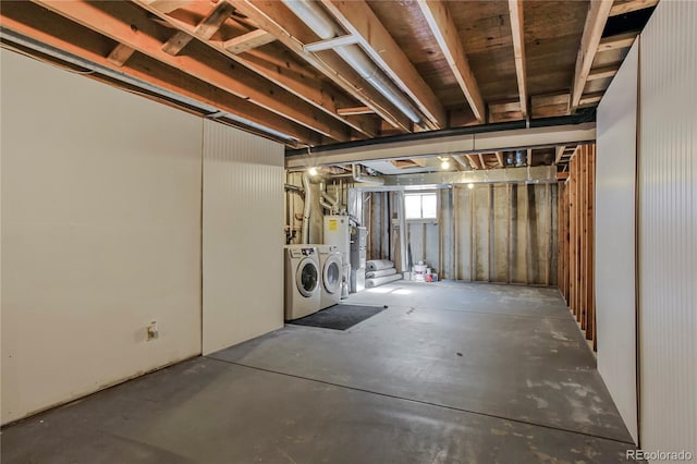 basement with water heater and washing machine and clothes dryer