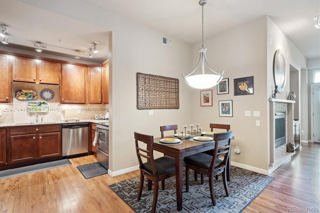 dining area featuring sink and light wood-type flooring