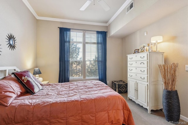 carpeted bedroom featuring ceiling fan and crown molding