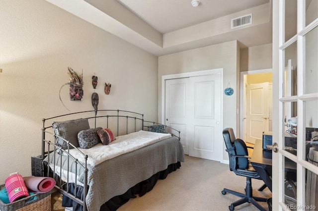 carpeted bedroom with a closet