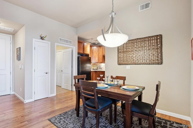 7865 Vallagio Ln Unit 207, Englewood, CO 80112 - dining area with baseboards and light wood-style floors