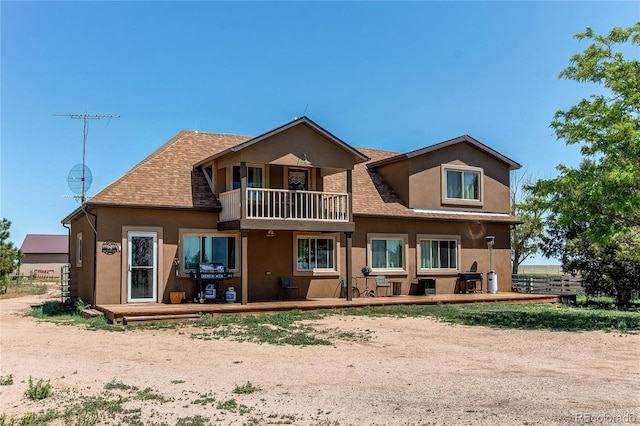 back of property with a balcony