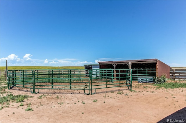 view of horse barn with a rural view