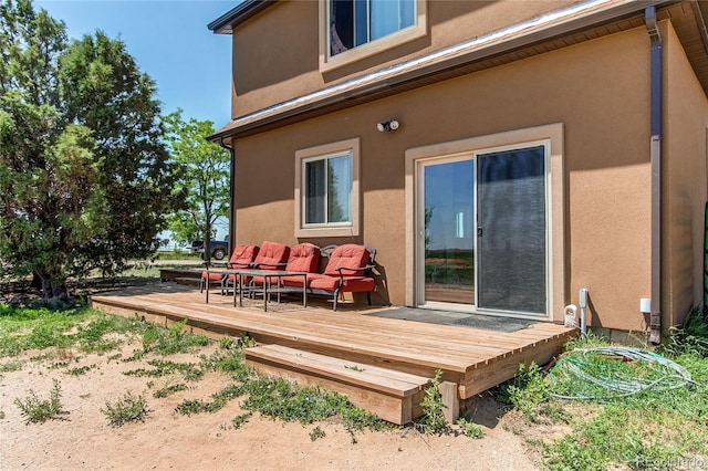 rear view of property featuring a wooden deck