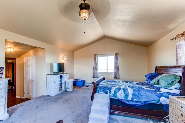 carpeted bedroom with a textured ceiling, ceiling fan, and vaulted ceiling