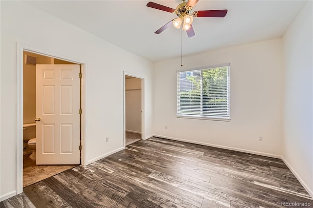 spare room with visible vents, a ceiling fan, baseboards, and wood finished floors