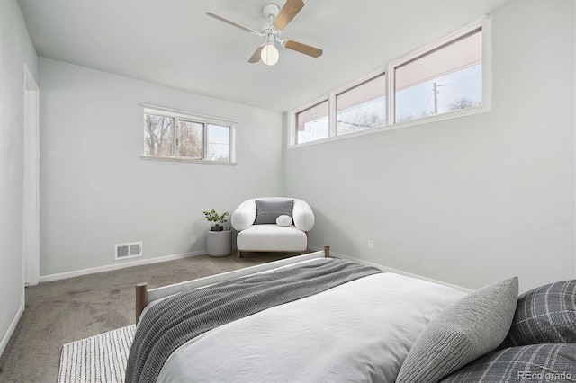 carpeted bedroom featuring visible vents, baseboards, and a ceiling fan