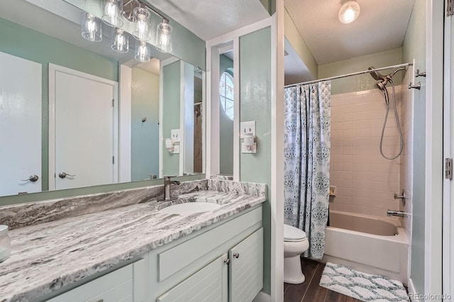 6311 Xavier St, Arvada, CO 80003 - full bathroom featuring toilet, vanity, shower / tub combo, and wood finished floors