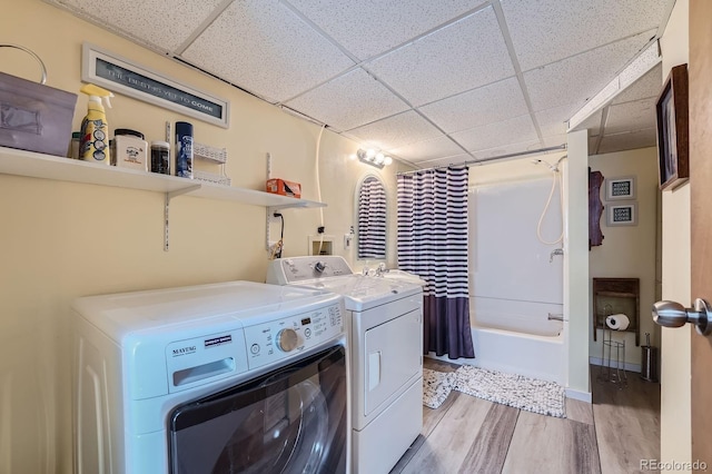 6311 Xavier St, Arvada, CO 80003 - washroom with washer and clothes dryer and light wood-style floors