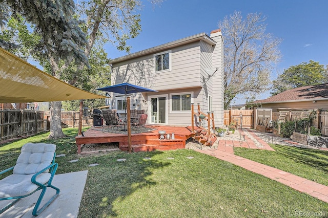 6311 Xavier St, Arvada, CO 80003 - back of property featuring a deck and a chimney