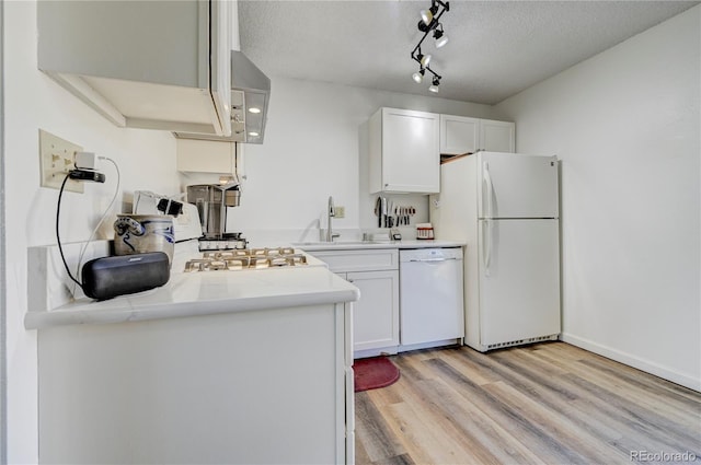 kitchen featuring white appliances, sink, a textured ceiling, light hardwood / wood-style floors, and white cabinetry