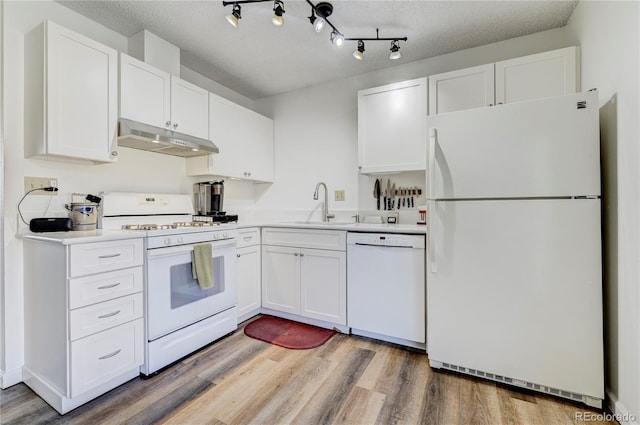 kitchen featuring light wood-type flooring, a textured ceiling, white appliances, sink, and white cabinets