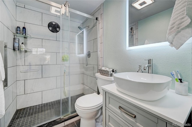 bathroom featuring tile patterned flooring, vanity, toilet, and an enclosed shower