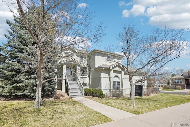 17309 Witten Ct, Parker, CO 80134 - traditional-style home with a garage, stucco siding, stairs, and a front yard