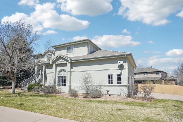 17309 Witten Ct, Parker, CO 80134 - traditional home with a front lawn, fence, and stucco siding