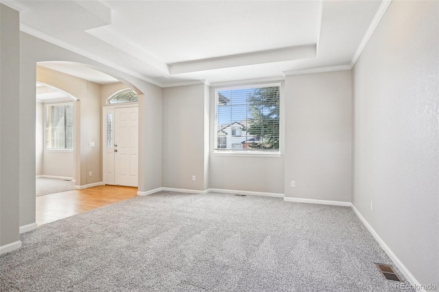 17309 Witten Ct, Parker, CO 80134 - carpeted spare room with visible vents, baseboards, a tray ceiling, and arched walkways