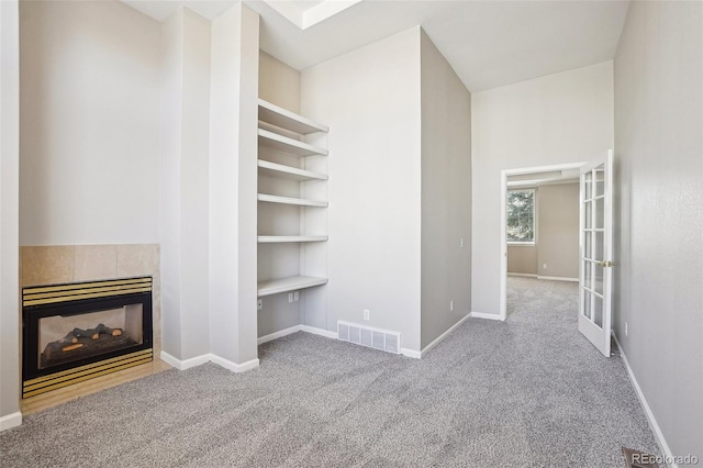 17309 Witten Ct, Parker, CO 80134 - unfurnished living room with a tile fireplace, baseboards, visible vents, and carpet floors