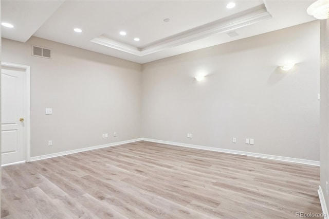 17309 Witten Ct, Parker, CO 80134 - empty room with a tray ceiling, baseboards, visible vents, and light wood-style flooring
