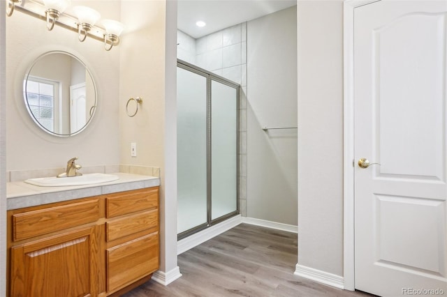 17309 Witten Ct, Parker, CO 80134 - full bathroom with a shower stall, wood finished floors, vanity, and baseboards