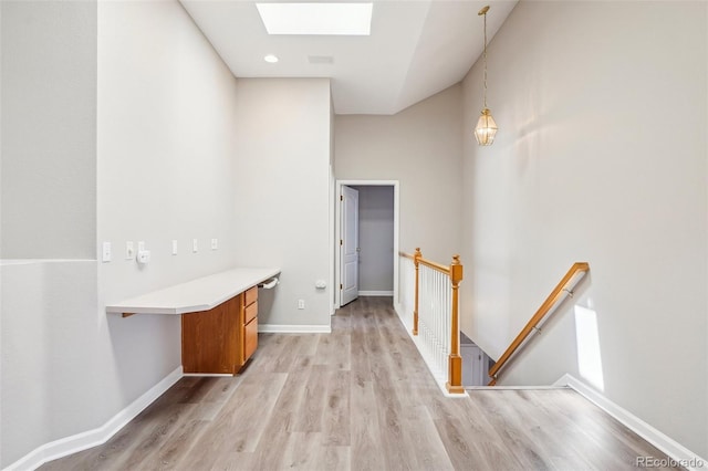 17309 Witten Ct, Parker, CO 80134 - hall featuring a skylight, an upstairs landing, light wood-style floors, and baseboards