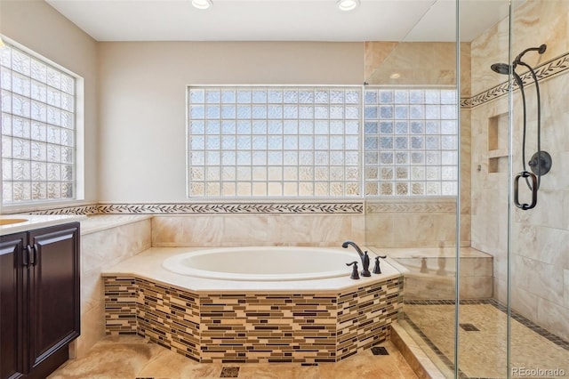 17309 Witten Ct, Parker, CO 80134 - bathroom with recessed lighting, vanity, a bath, and a stall shower
