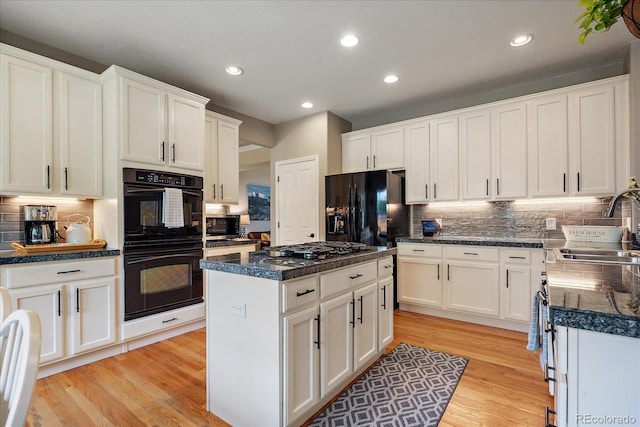 2861 Madison Ln, Broomfield, CO 80023 - kitchen featuring black appliances, a sink, decorative backsplash, light wood finished floors, and recessed lighting