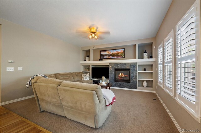 2861 Madison Ln, Broomfield, CO 80023 - living room with baseboards, a fireplace, built in features, a ceiling fan, and carpet floors