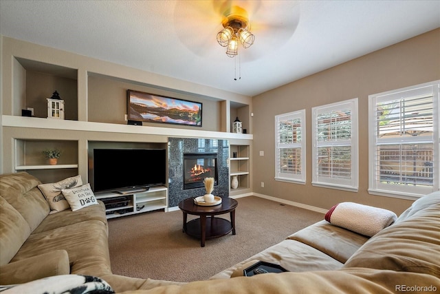 2861 Madison Ln, Broomfield, CO 80023 - carpeted living room featuring built in features, a ceiling fan, baseboards, and a glass covered fireplace