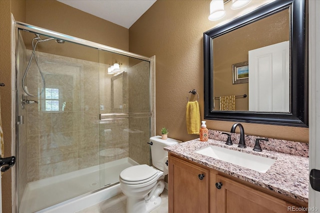 2861 Madison Ln, Broomfield, CO 80023 - bathroom with toilet, a stall shower, a textured wall, and vanity