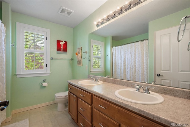 2861 Madison Ln, Broomfield, CO 80023 - full bathroom featuring healthy amount of natural light, baseboards, double vanity, and toilet
