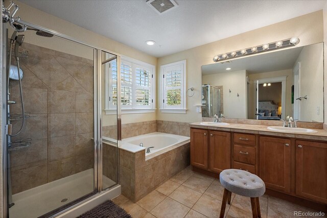 2861 Madison Ln, Broomfield, CO 80023 - ensuite bathroom with tile patterned flooring, a stall shower, a bath, double vanity, and recessed lighting