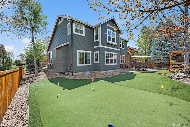 2861 Madison Ln, Broomfield, CO 80023 - back of house with a putting area, a patio, and a fenced backyard