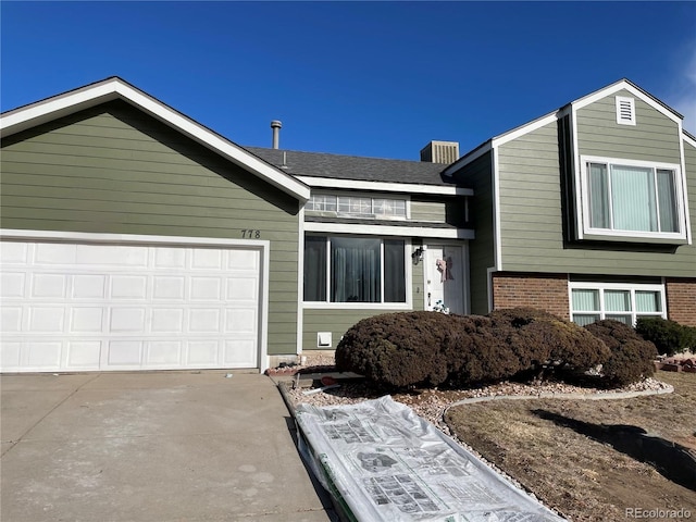 778 S Fairplay Ct, Aurora, CO 80012 - view of front of home featuring concrete driveway, an attached garage, and brick siding