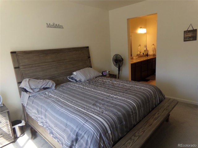 carpeted bedroom featuring connected bathroom