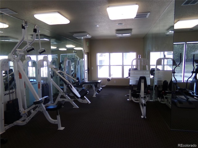 gym featuring a textured ceiling