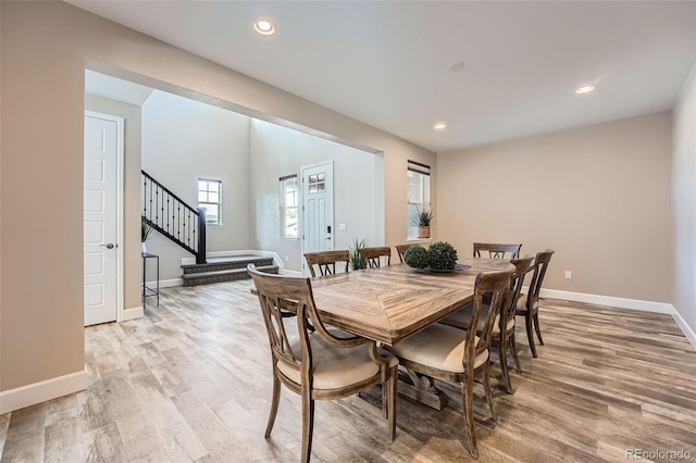 dining area featuring baseboards, stairway, recessed lighting, and light wood-style floors