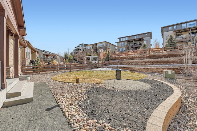 view of yard featuring fence and a residential view