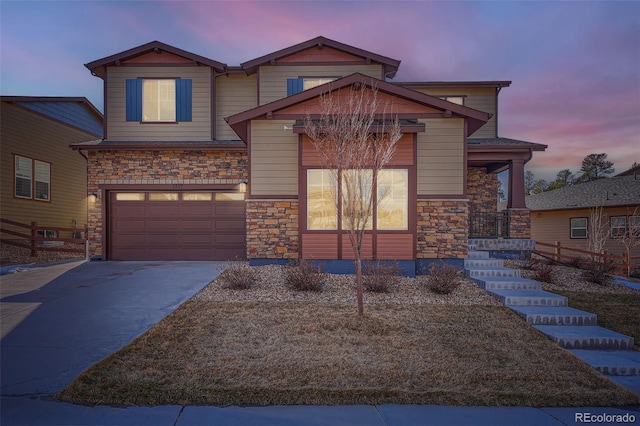 view of front facade with stone siding, driveway, and an attached garage