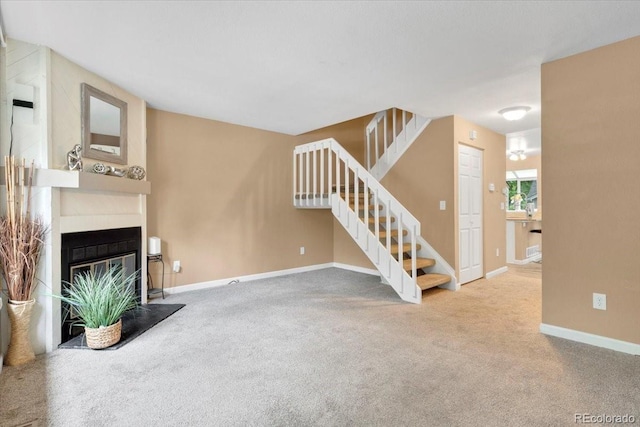 18131 E Arizona Ave Unit B, Aurora, CO 80017 - unfurnished living room with stairway, carpet floors, and a glass covered fireplace