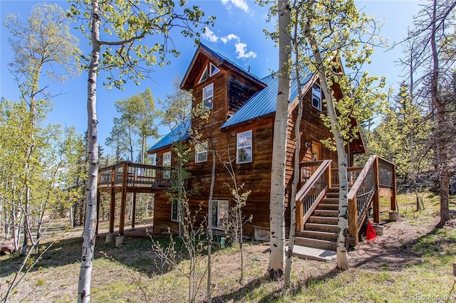 362 Kite Ct, Jefferson, CO 80456 - back of house featuring stairs, a wooden deck, and a metal roof