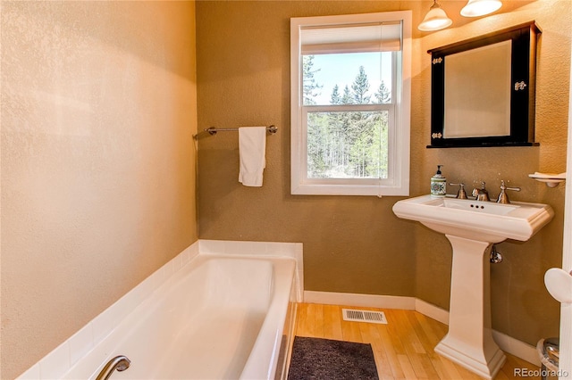 362 Kite Ct, Jefferson, CO 80456 - bathroom featuring a bath and wood finished floors