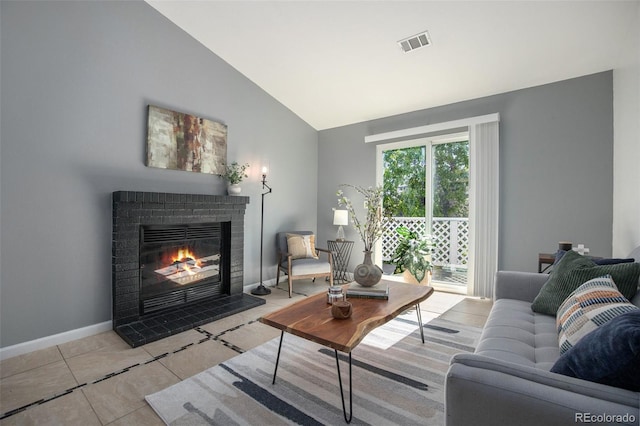 360 S Estes St Unit C, Lakewood, CO 80228 - living area with a fireplace, high vaulted ceiling, tile patterned flooring, and baseboards
