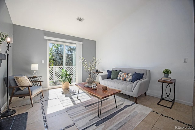 360 S Estes St Unit C, Lakewood, CO 80228 - living area with light tile patterned flooring, lofted ceiling, and baseboards