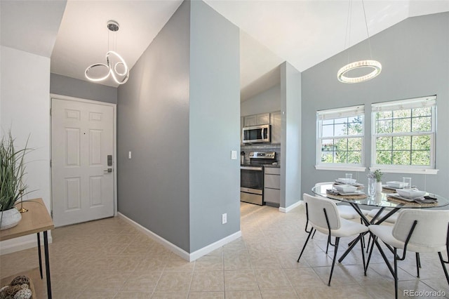 360 S Estes St Unit C, Lakewood, CO 80228 - dining space with a chandelier, baseboards, light tile patterned flooring, and high vaulted ceiling