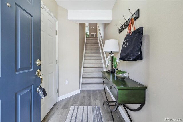 2945 W Riverwalk Cir Unit B, Littleton, CO 80123 - entrance foyer featuring wood finished floors, stairs, and baseboards