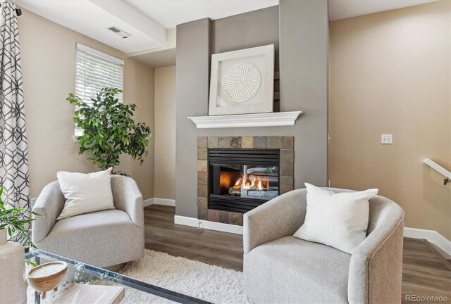 2945 W Riverwalk Cir Unit B, Littleton, CO 80123 - living area featuring a fireplace, baseboards, and wood finished floors