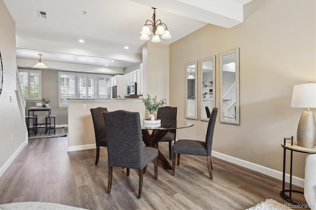 2945 W Riverwalk Cir Unit B, Littleton, CO 80123 - dining area with wood finished floors, baseboards, a chandelier, and recessed lighting