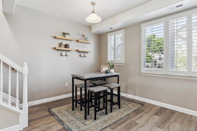 2945 W Riverwalk Cir Unit B, Littleton, CO 80123 - dining area featuring baseboards, wood finished floors, and stairway