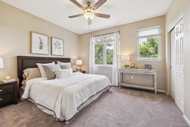2945 W Riverwalk Cir Unit B, Littleton, CO 80123 - carpeted bedroom featuring a closet, a ceiling fan, and baseboards